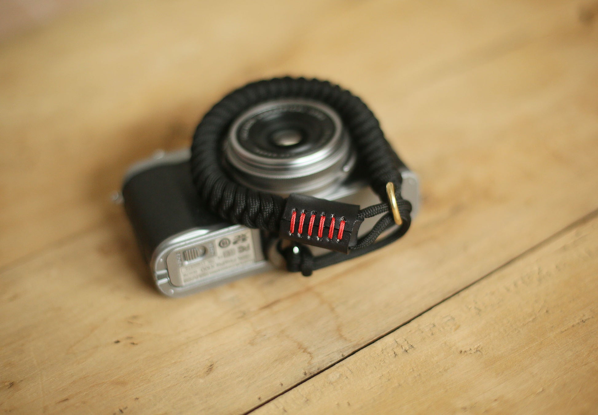 Windmup black handwoven wrist strap on wooden surface