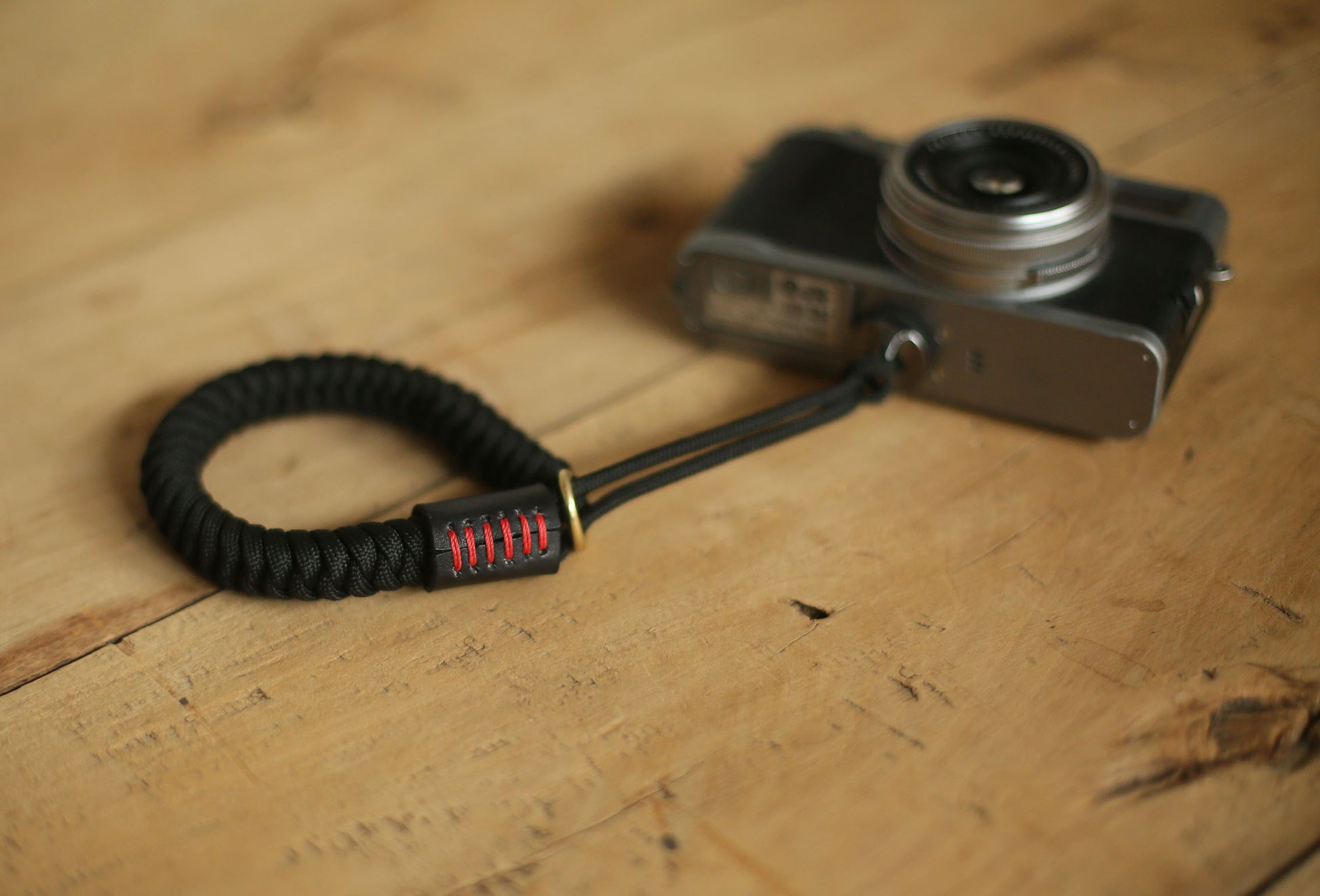 Minimalist black camera wrist strap with leather accent