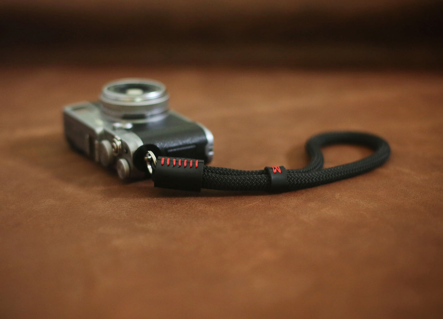 Red stitch detail on black leather endcap