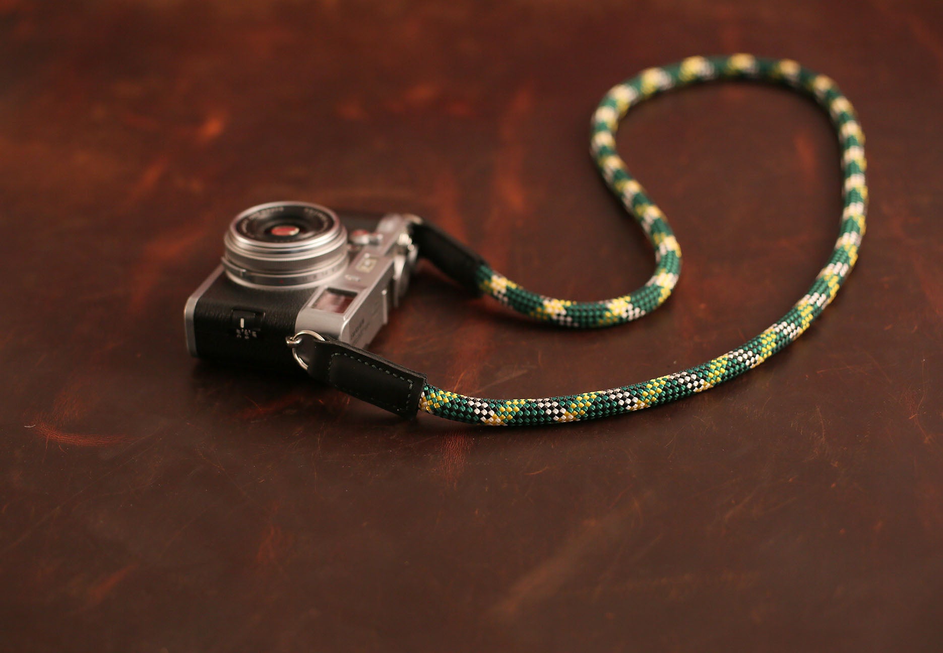 Durable climbing rope strap on brown background