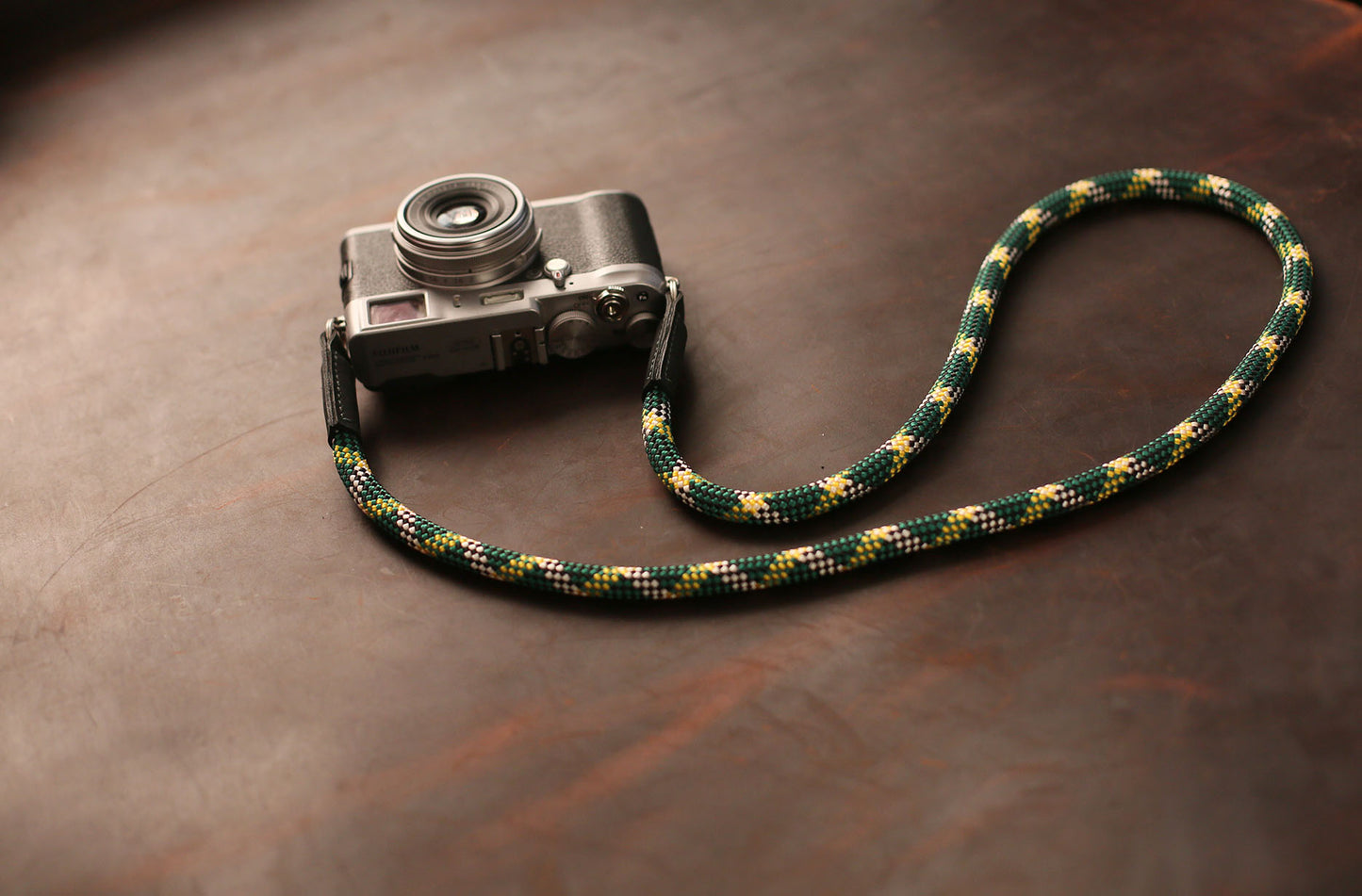 Vintage camera with green rope neck strap