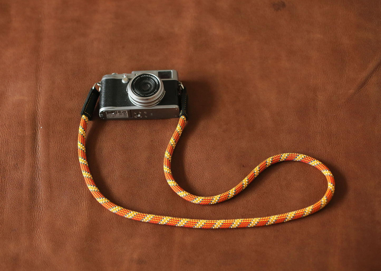 Handmade rope camera strap by Windmup in orange with gold accents
