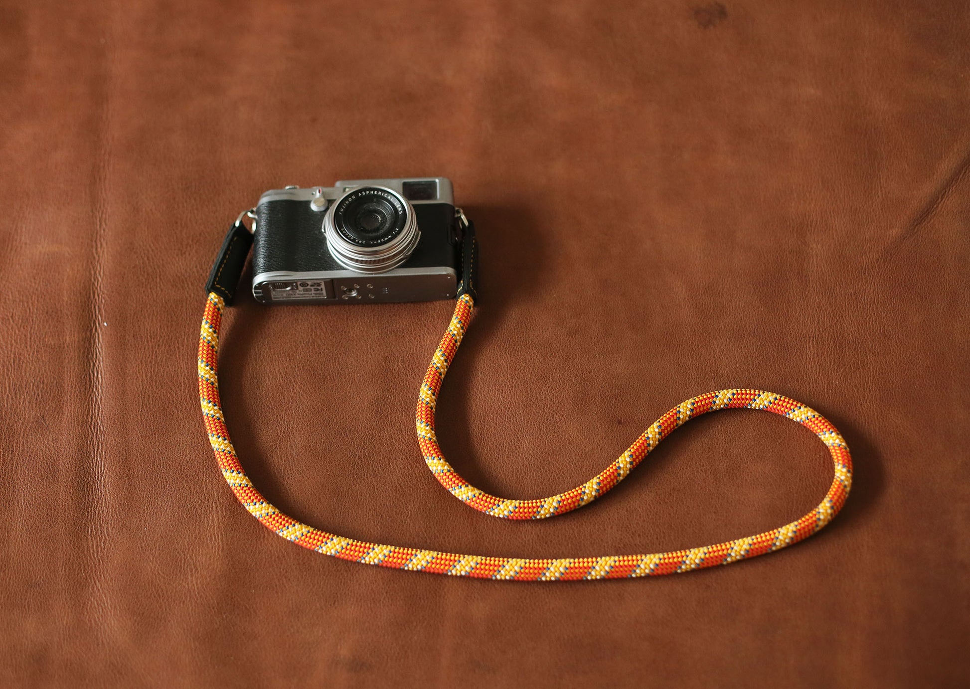 Handmade rope camera strap by Windmup in orange with gold accents