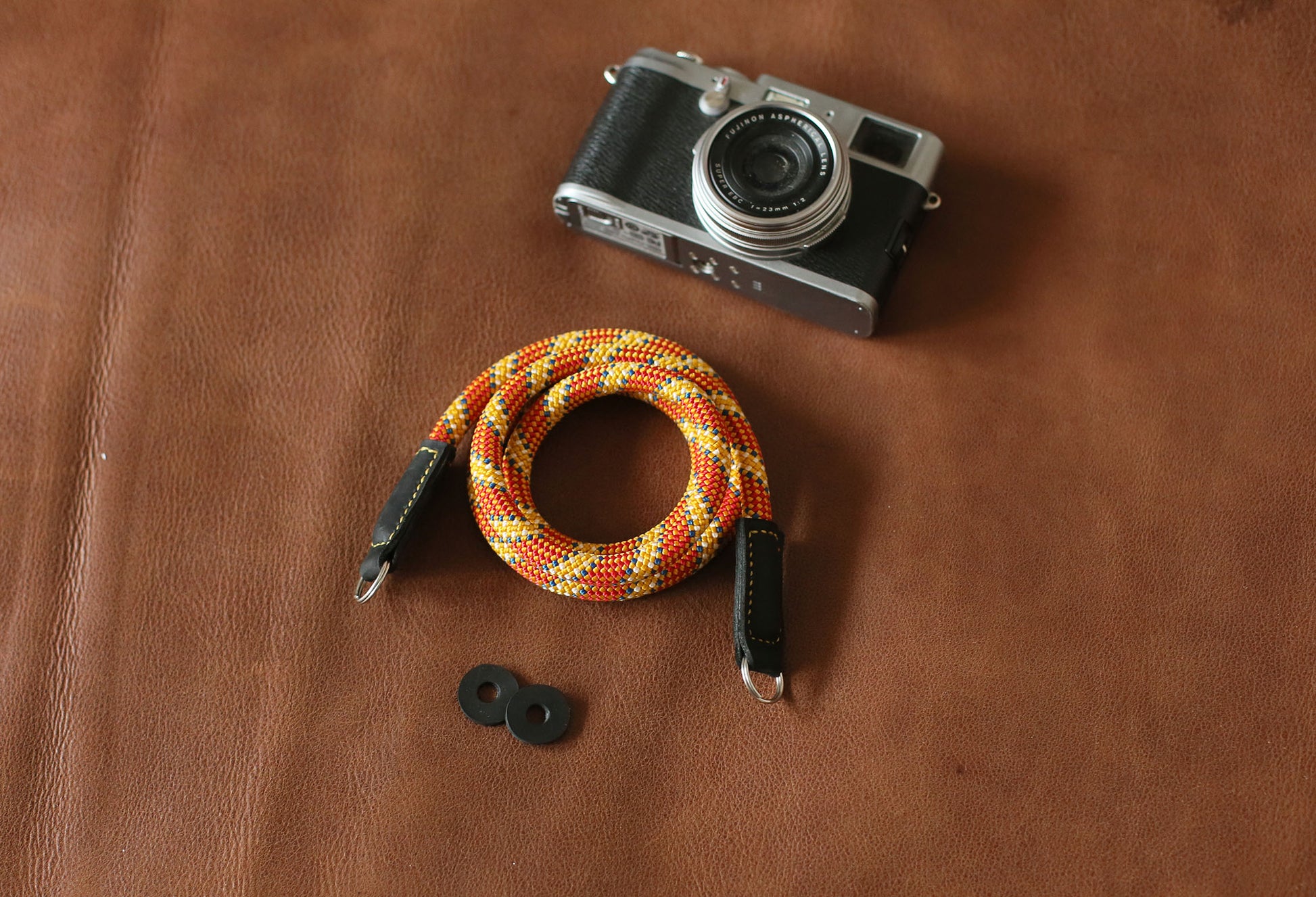 Orange patterned camera strap with vegetable-tanned black leather