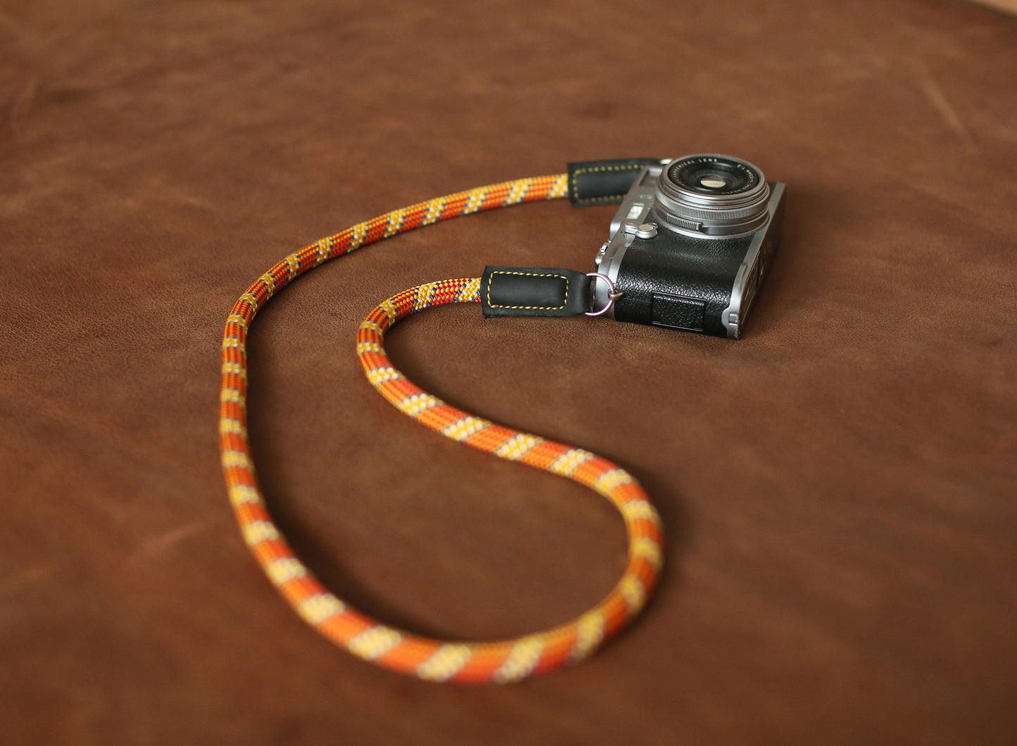 Stylish handmade climbing rope strap with black leather protectors