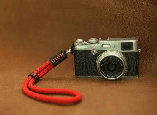 Handmade red climbing rope wrist strap with leather ends – secure fit for city street shoots