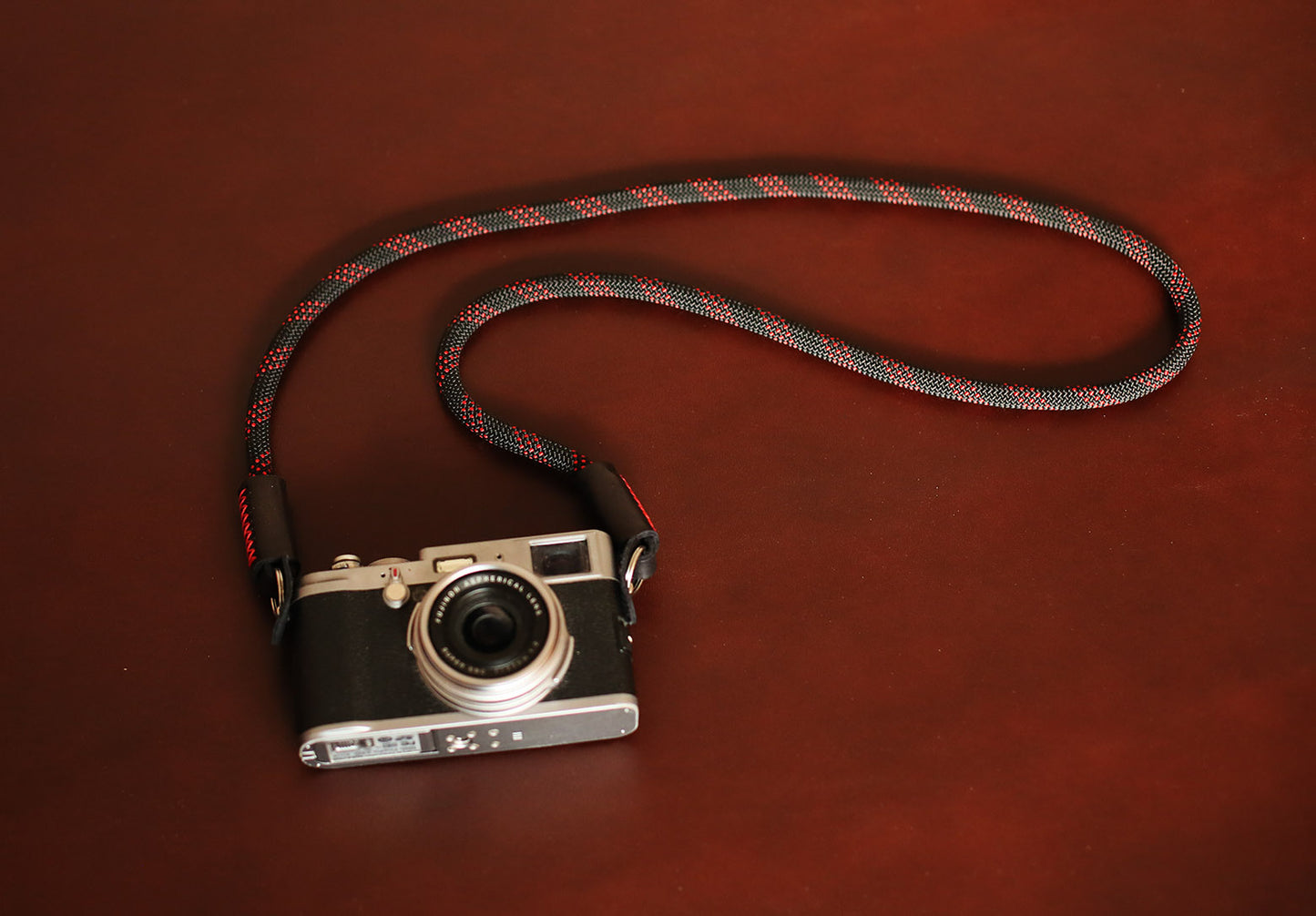 Windmup camera strap with tan leather ends and red stitching