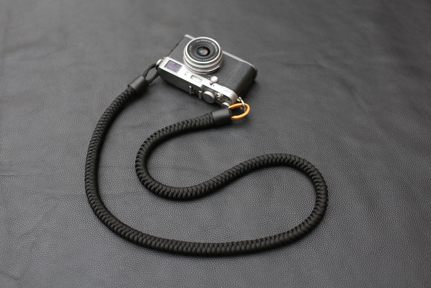 Side view of cylindrical leather strap end with clasp
