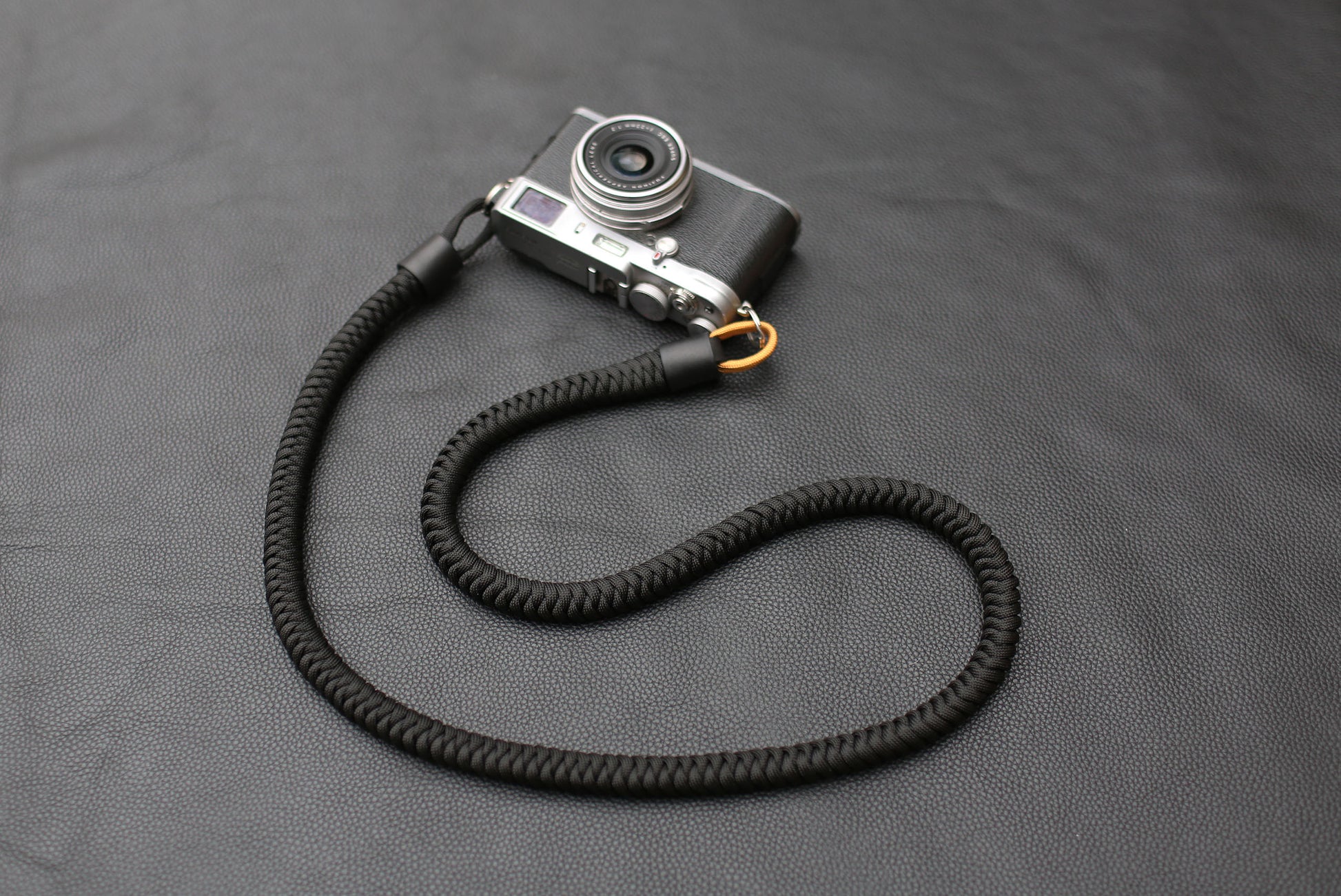 Side view of cylindrical leather strap end with clasp