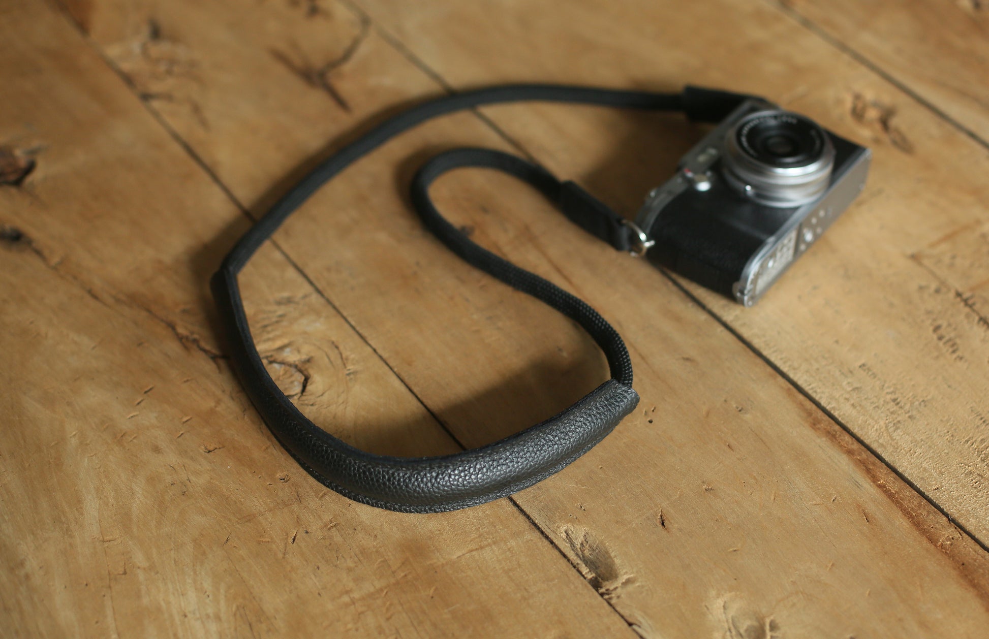 Close up of full grain cylindrical leather shoulder pad texture on camera strap