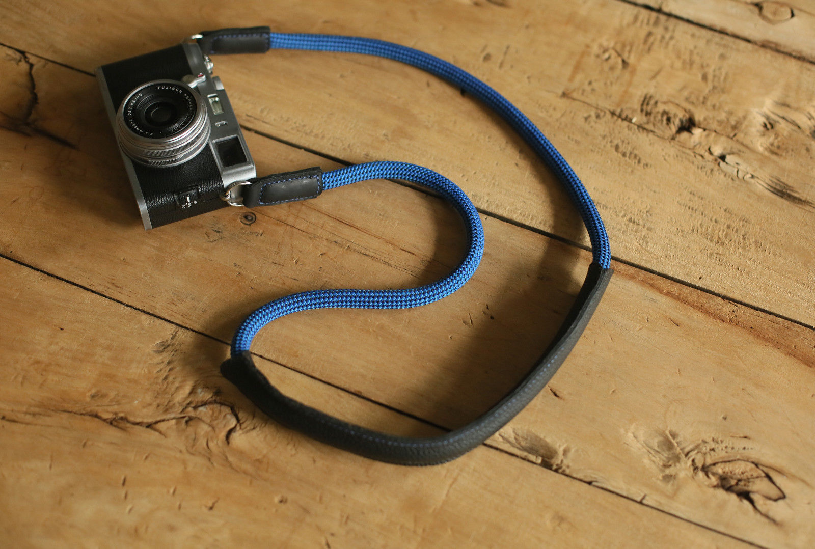 Close-up of hand-stitched black leather pad on camera strap