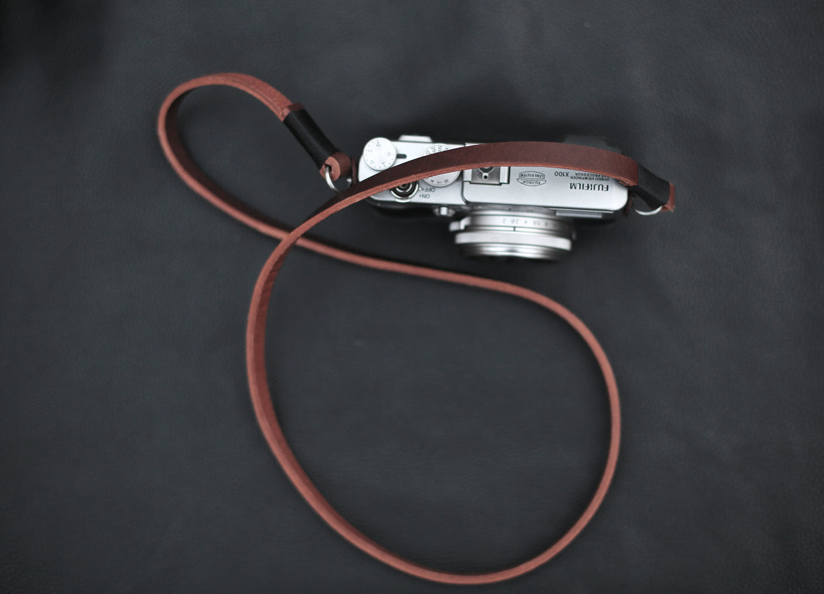 Slim 9mm wide brown leather camera strap with metal rings