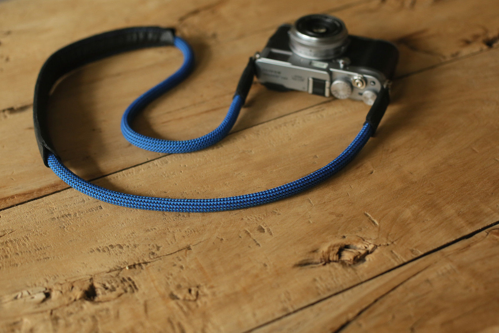 Blue rope camera strap attached to vintage camera