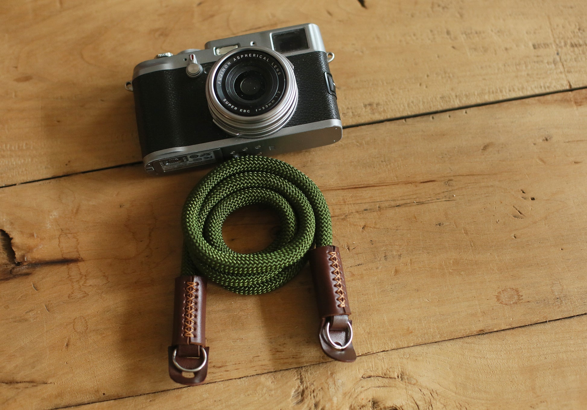Army green rope strap attached to Fujifilm camera
