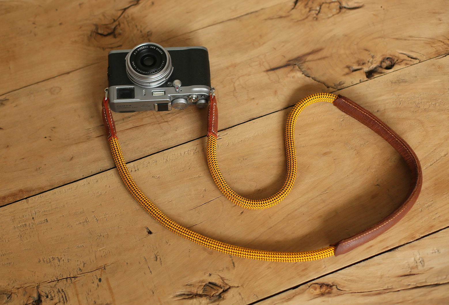 gold rope camera strap with padded leather shoulder section