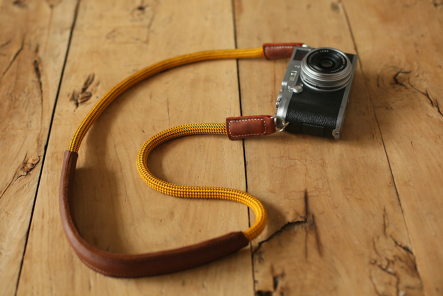 vintage camera with gold rope strap