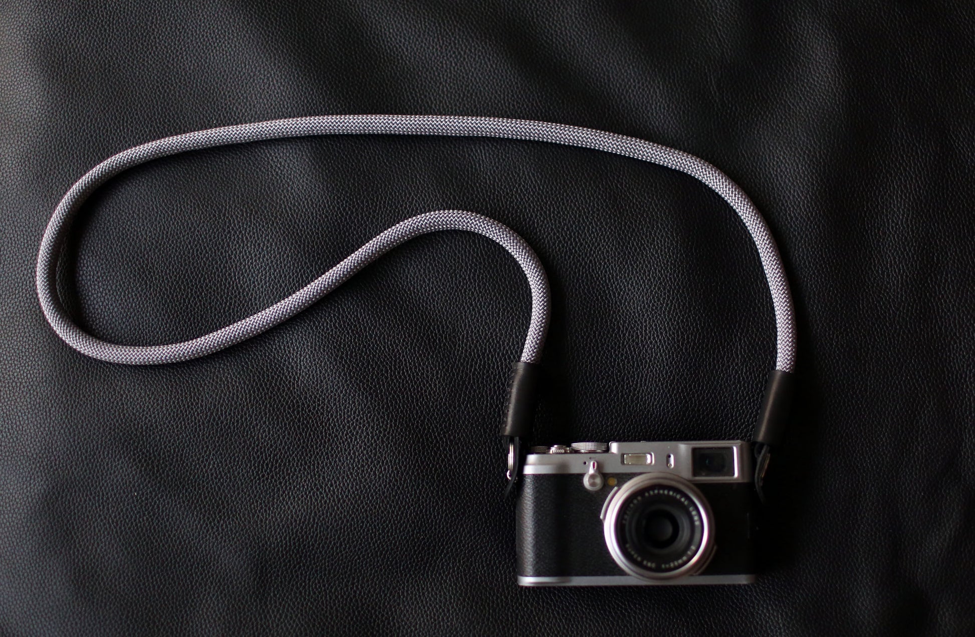 Close-up of leather end and stitching on gray climbing rope strap