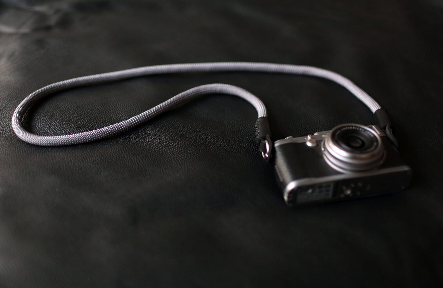 Minimalist gray climbing rope strap with black leather protector
