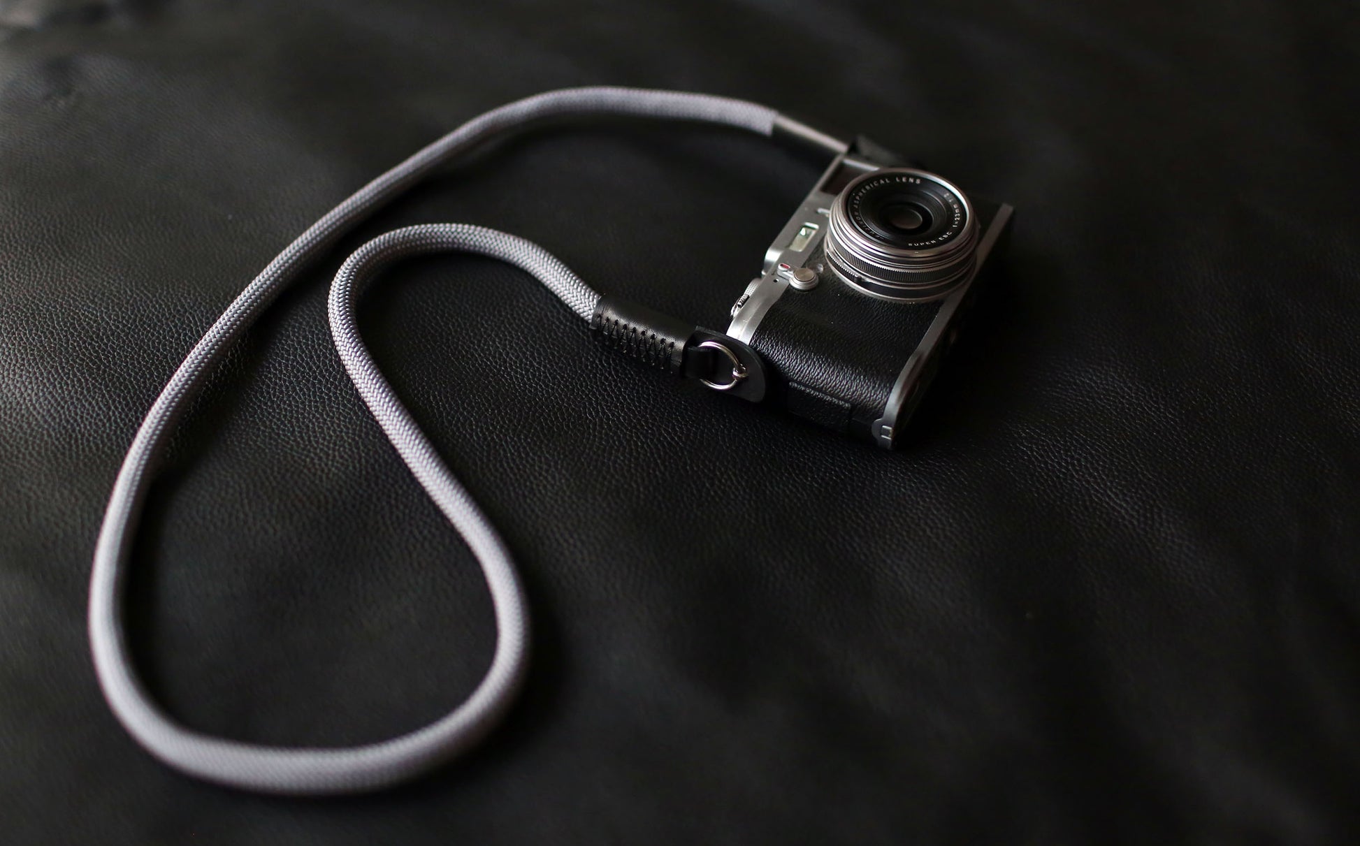 Fujifilm camera with attached gray climbing rope strap