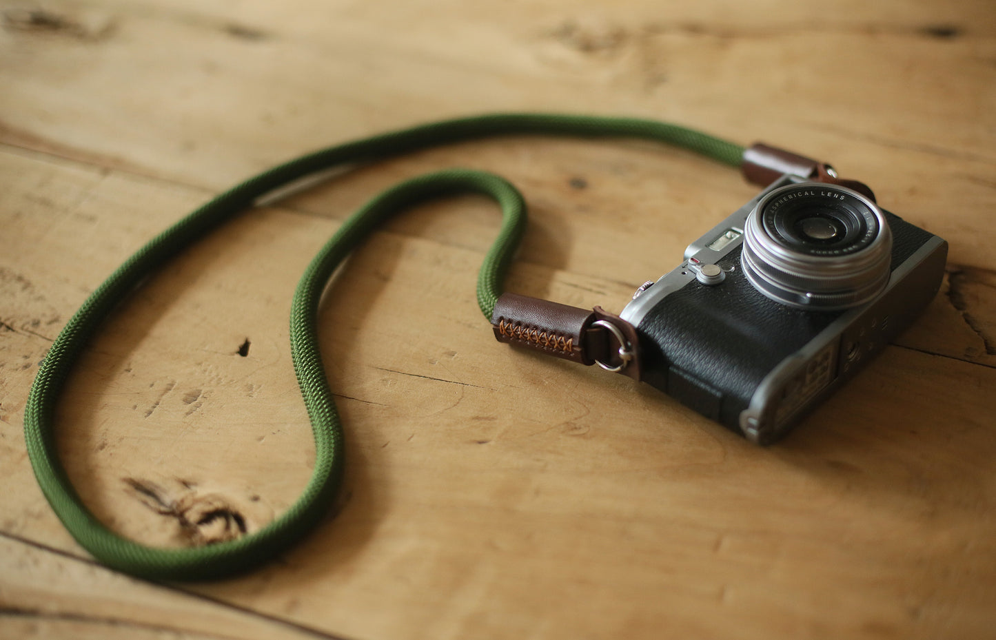 Close-up of hand-stitched tan leather camera strap end