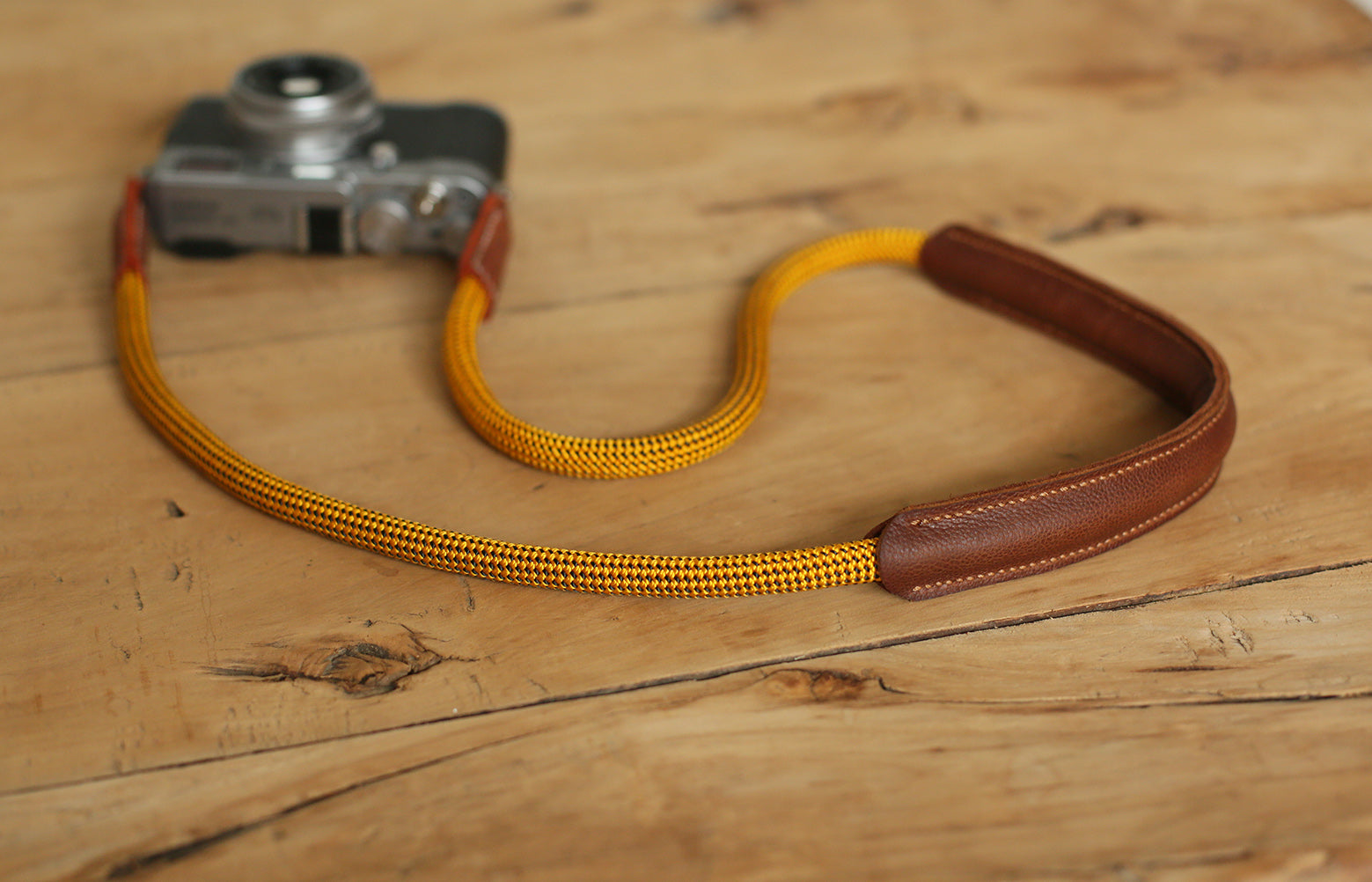 handmade golden rope strap on wooden background