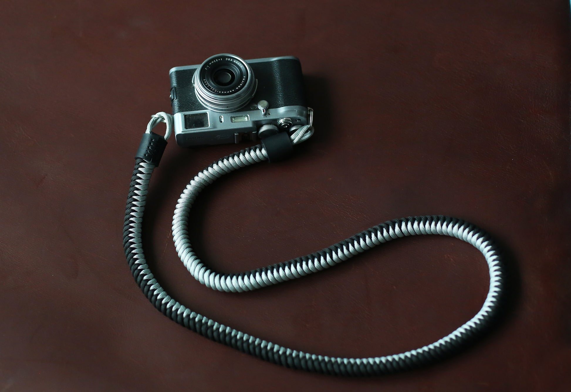 Black and silver two-tone camera strap with leather ends