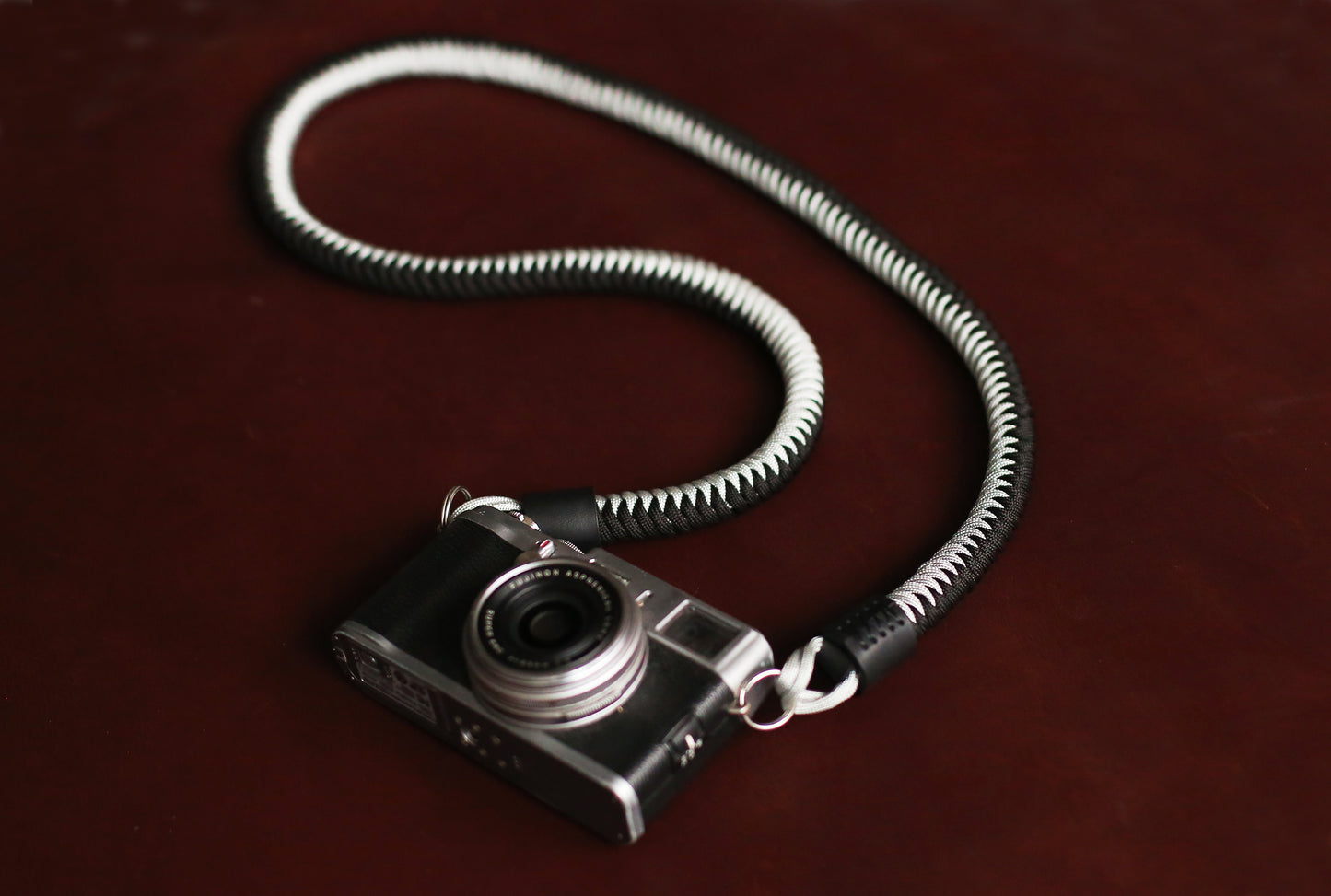 Stylish two-tone camera strap handwoven from paracord and leather