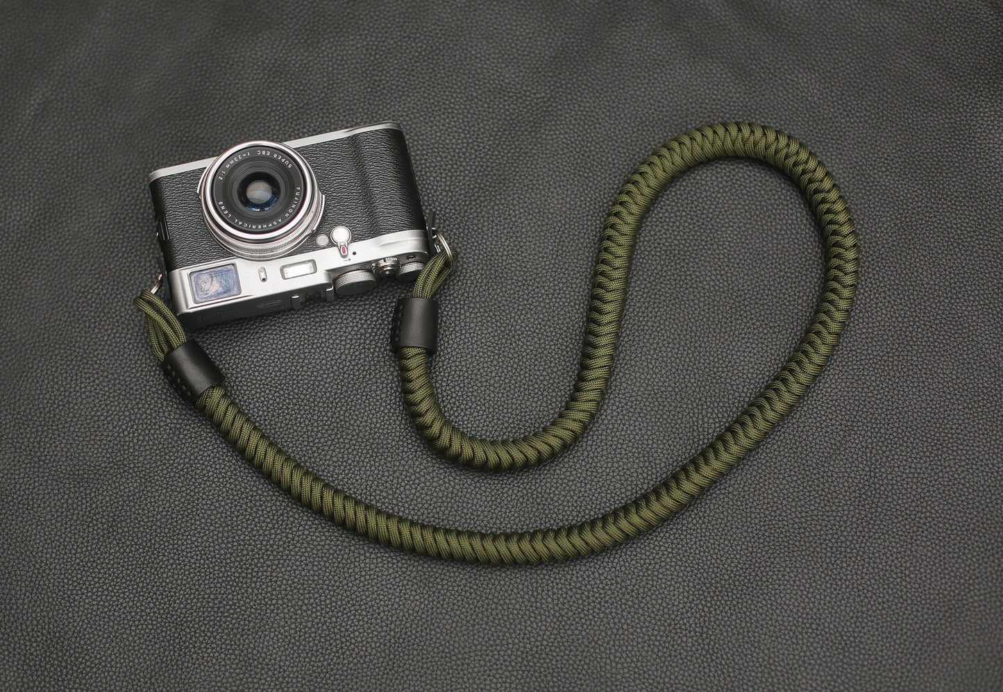 Black full-grain leather ends with precise hand stitching – camera strap detail