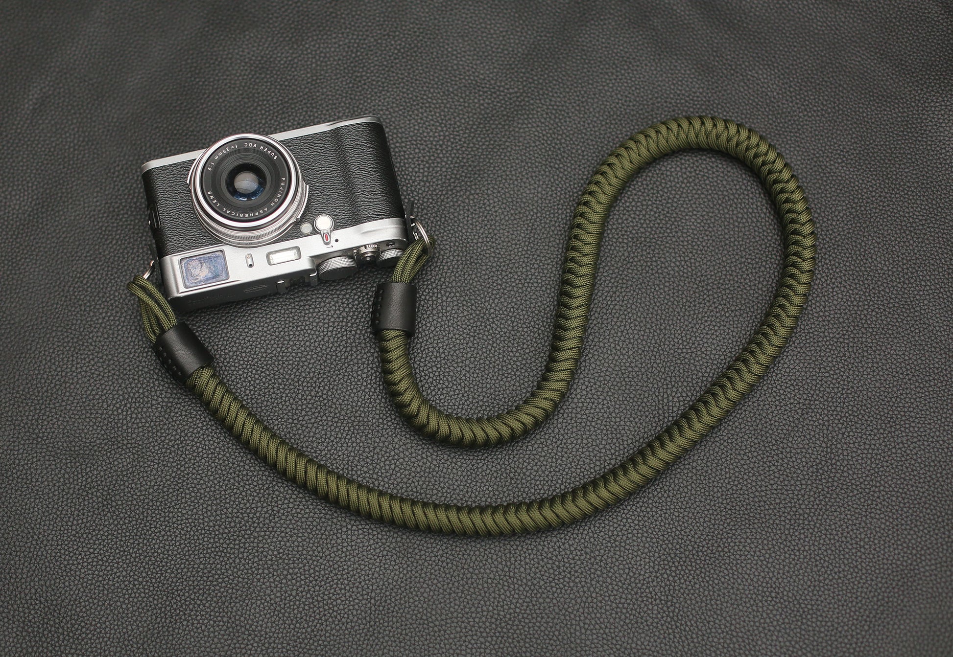 Black full-grain leather ends with precise hand stitching – camera strap detail