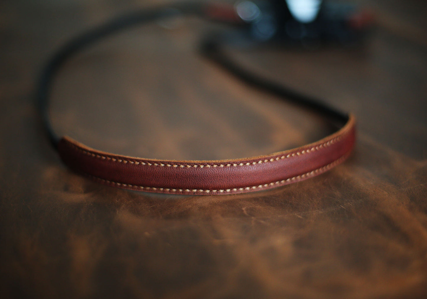 Brown shoulder pad detail on black strap