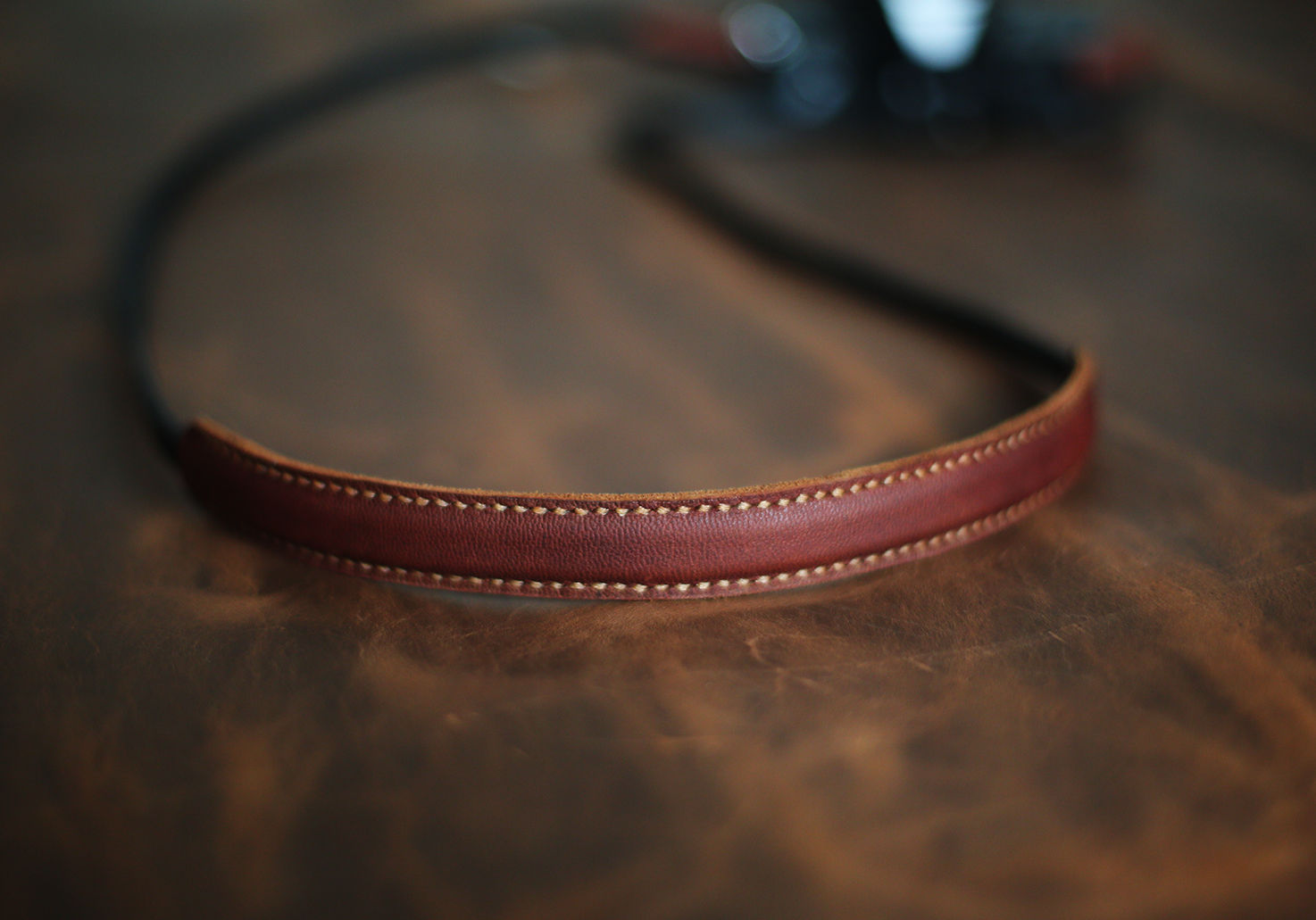 Brown shoulder pad detail on black strap