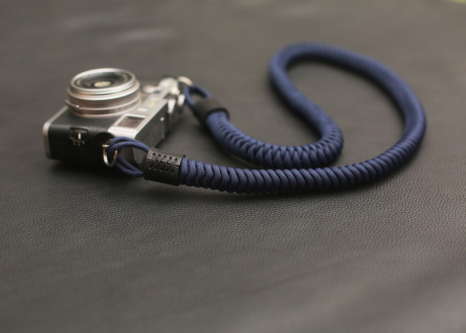 Handwoven navy blue paracord camera strap on mirrorless camera