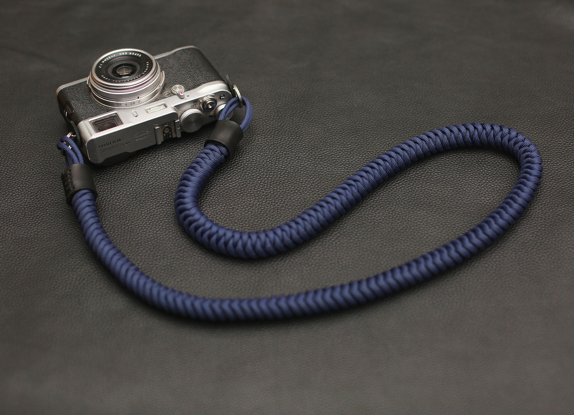 Black leather end with stitched detail on navy paracord strap