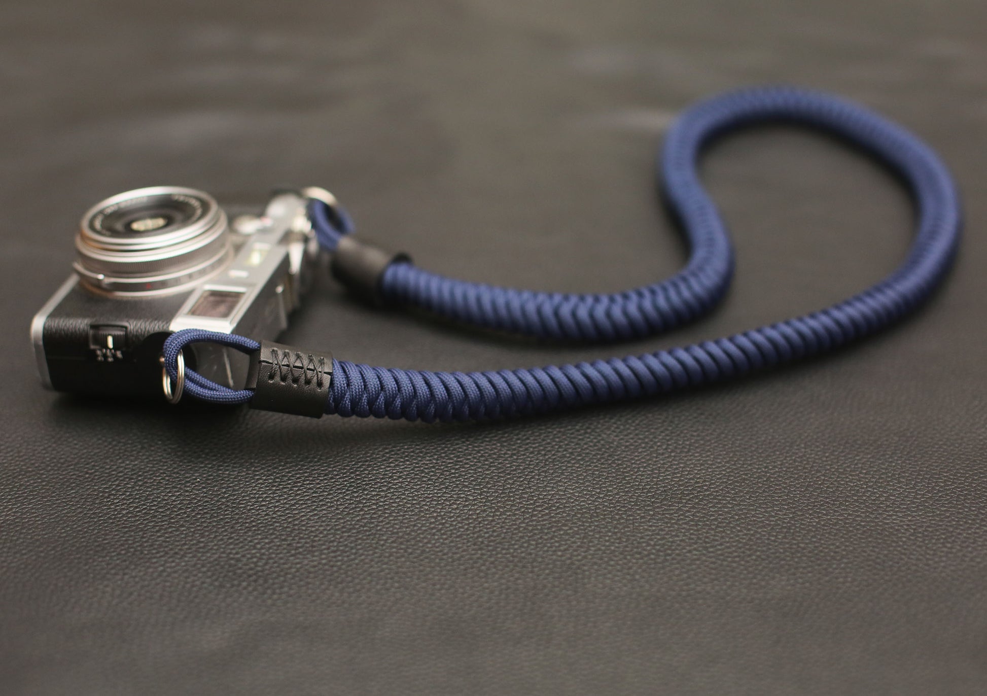 Navy paracord strap displayed with vintage rangefinder camera