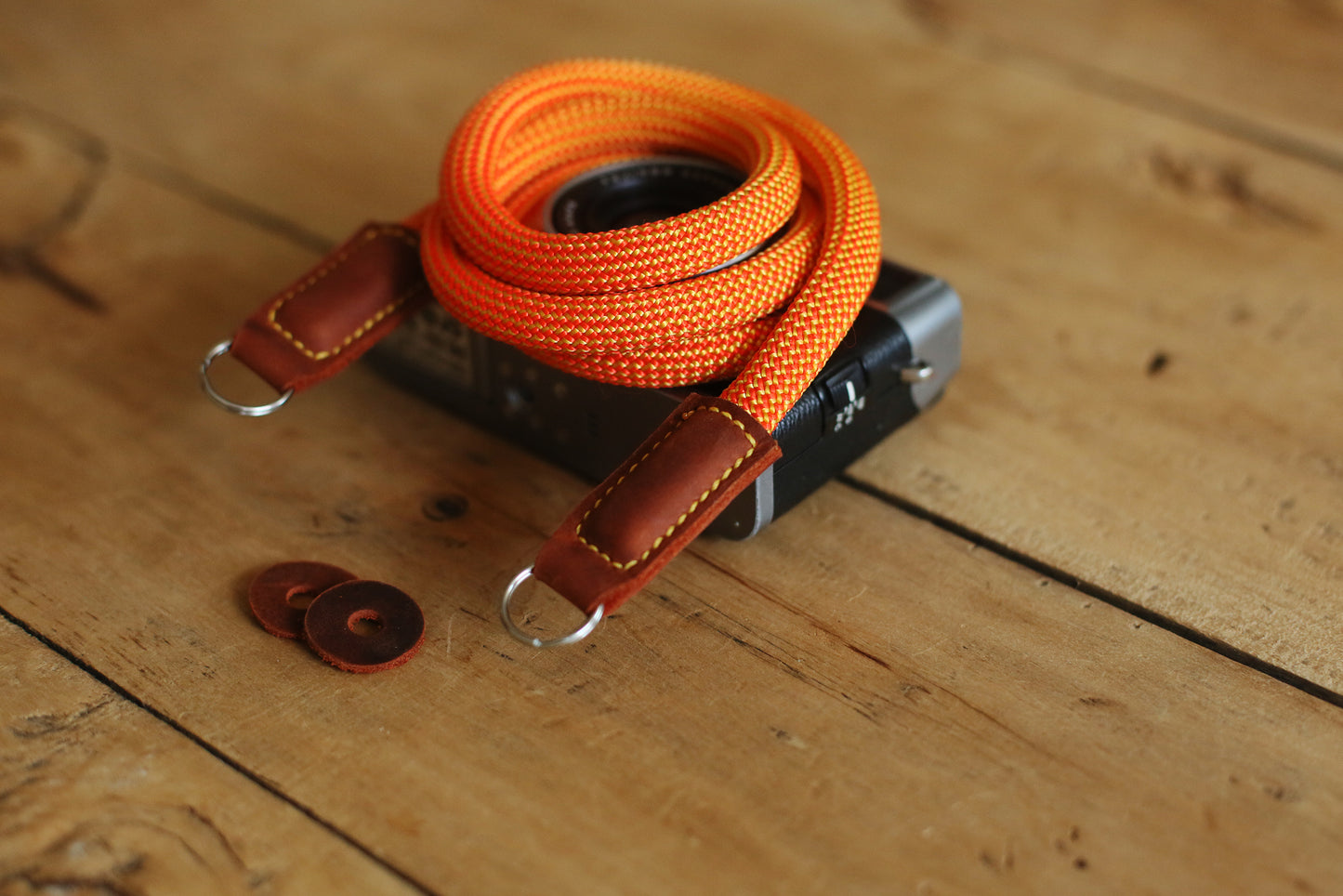 orange camera strap with retro silver camera
