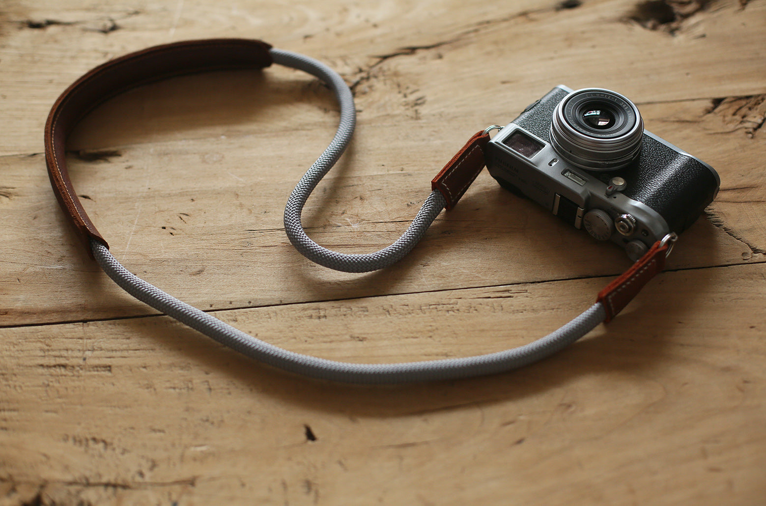 Side view of Windmup gray rope strap resting on desk light