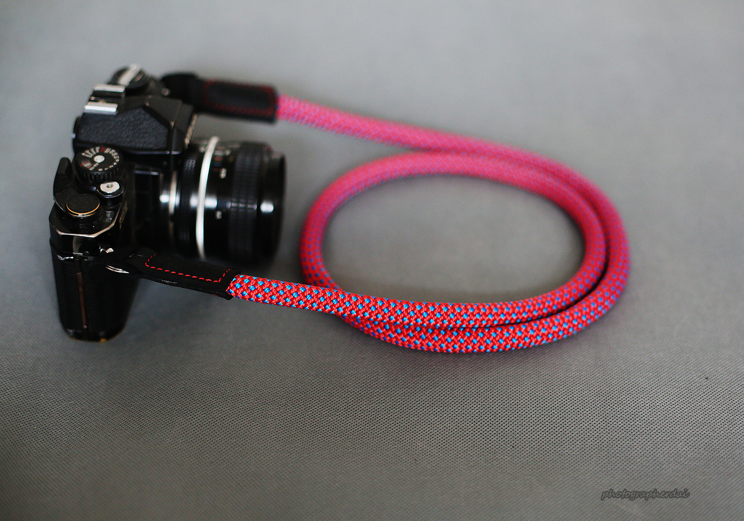 Hand stitched multi color thread detail on purple climbing rope camera strap