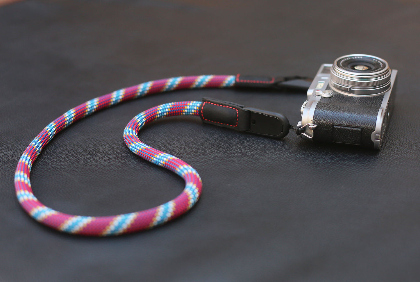Black leather end with red stitching and anchor link