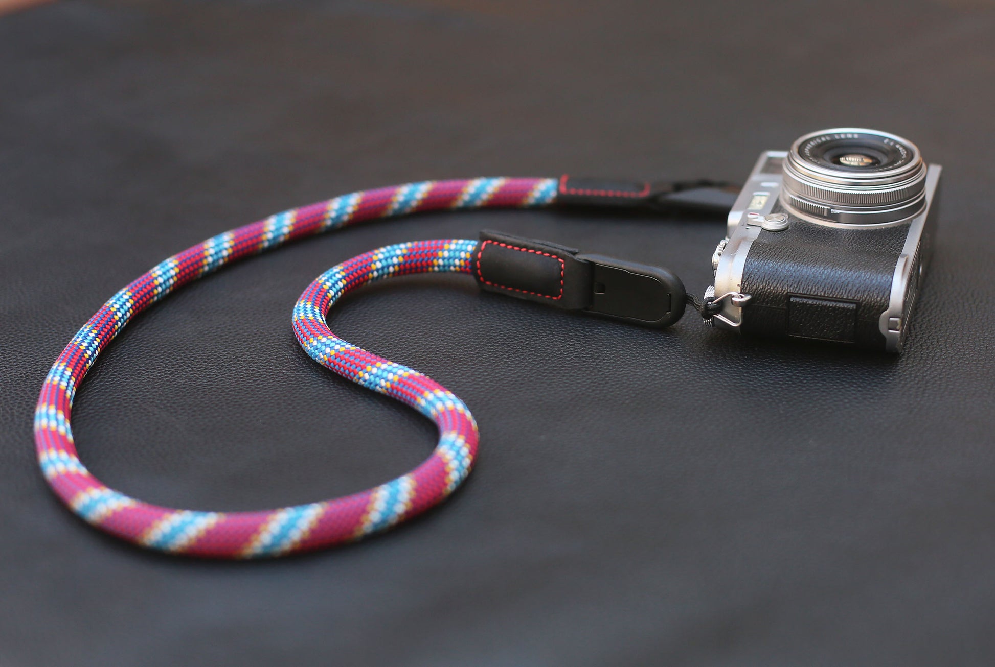 Black leather end with red stitching and anchor link