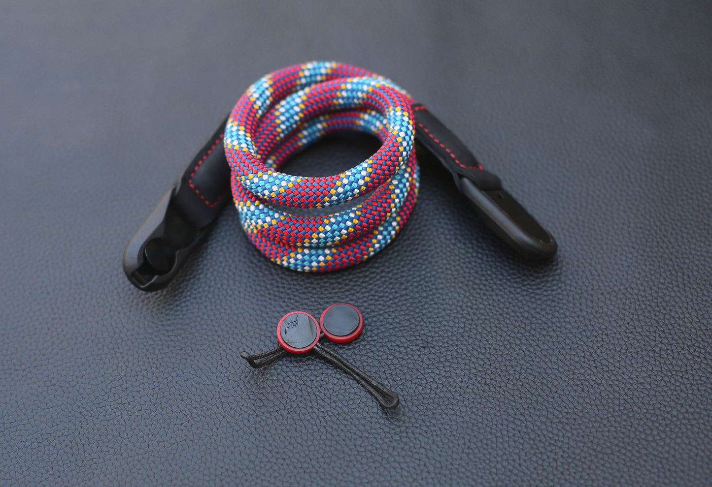 Hand holding camera with quick-release strap attached