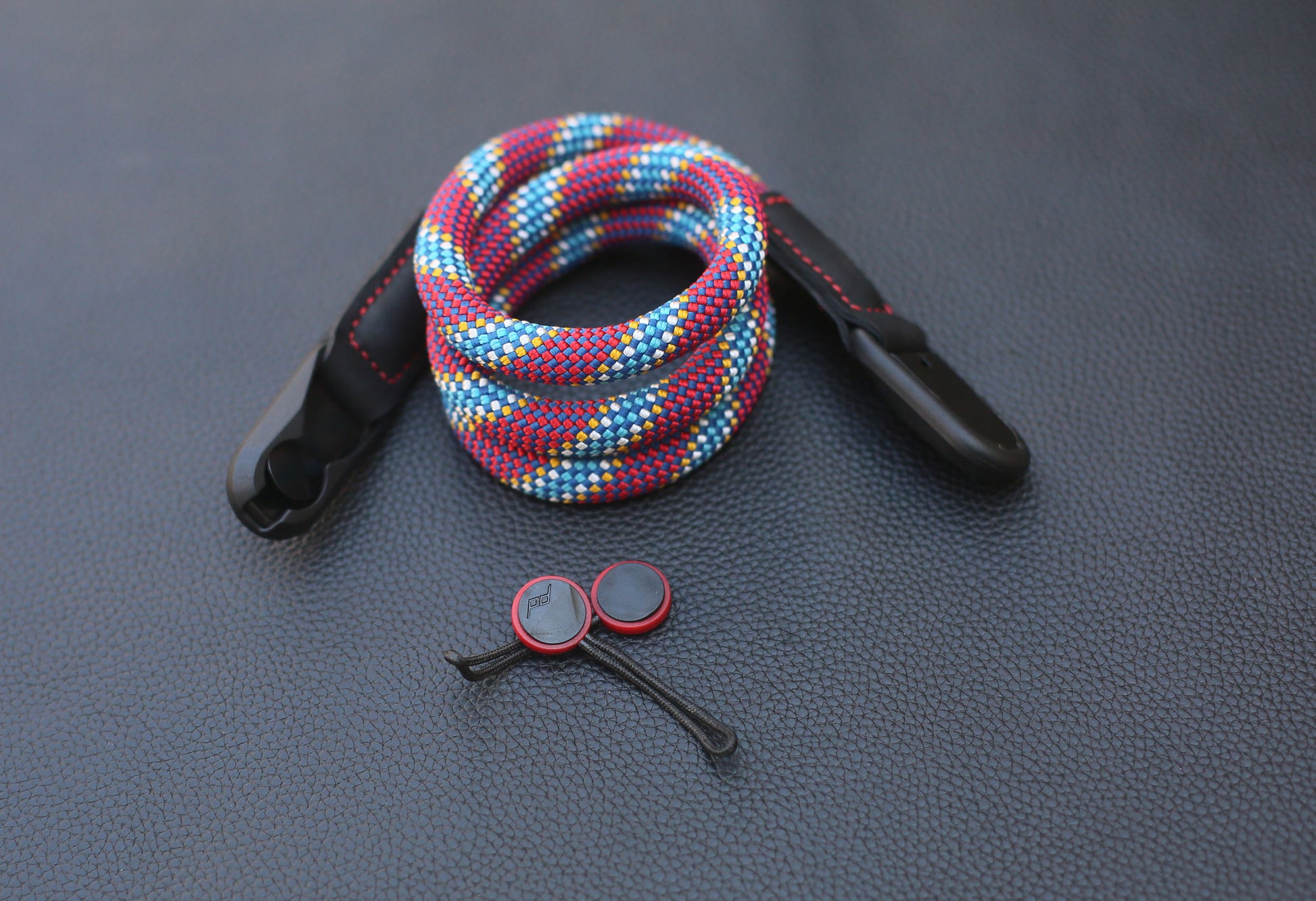 Hand holding camera with quick-release strap attached