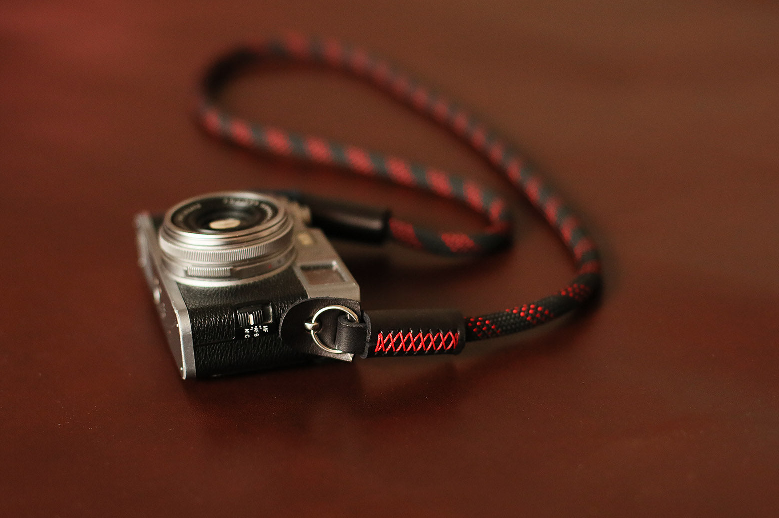 Black and red rope strap with brass rings