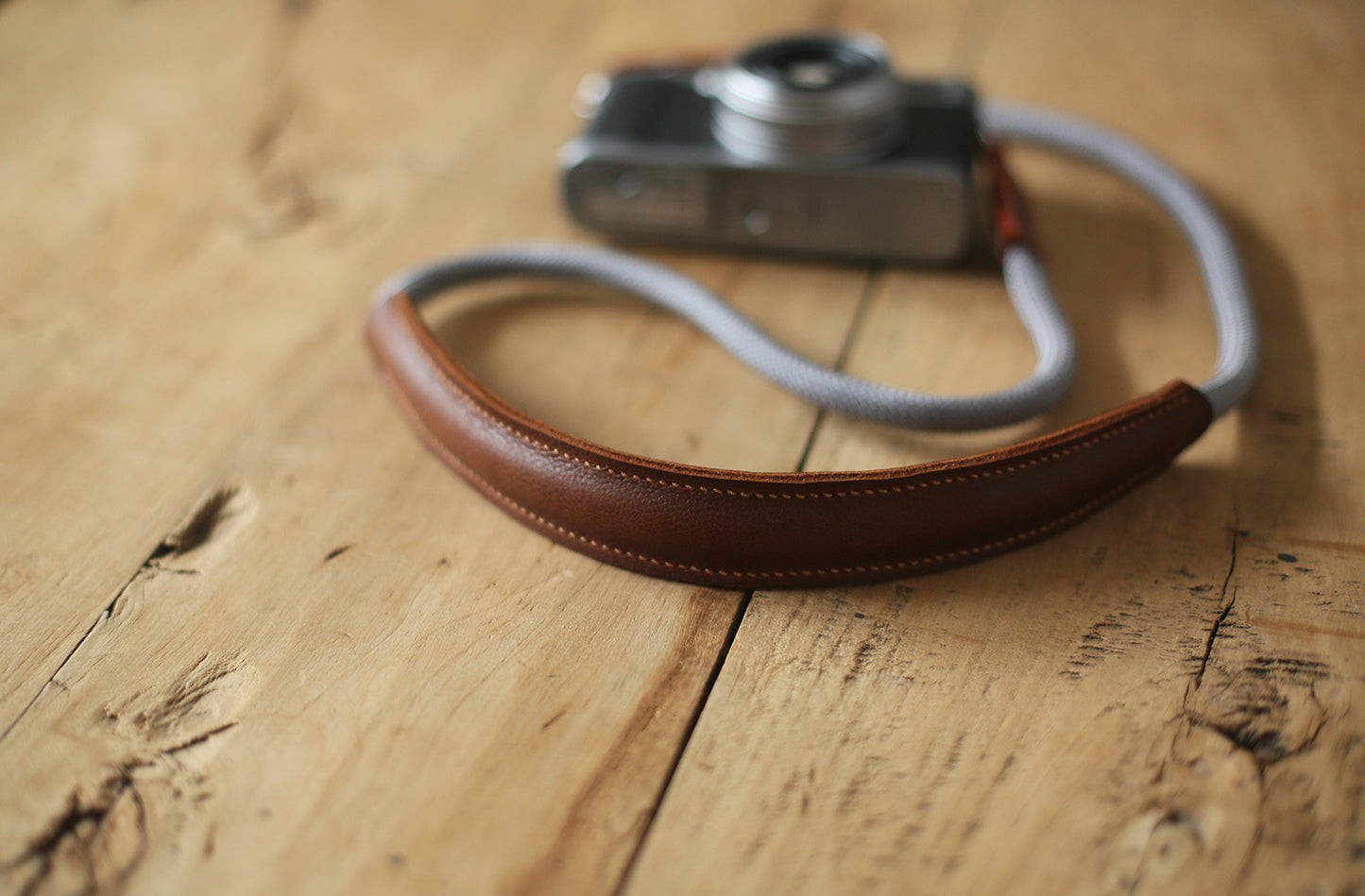 Lightweight travel camera strap on wooden tabletop