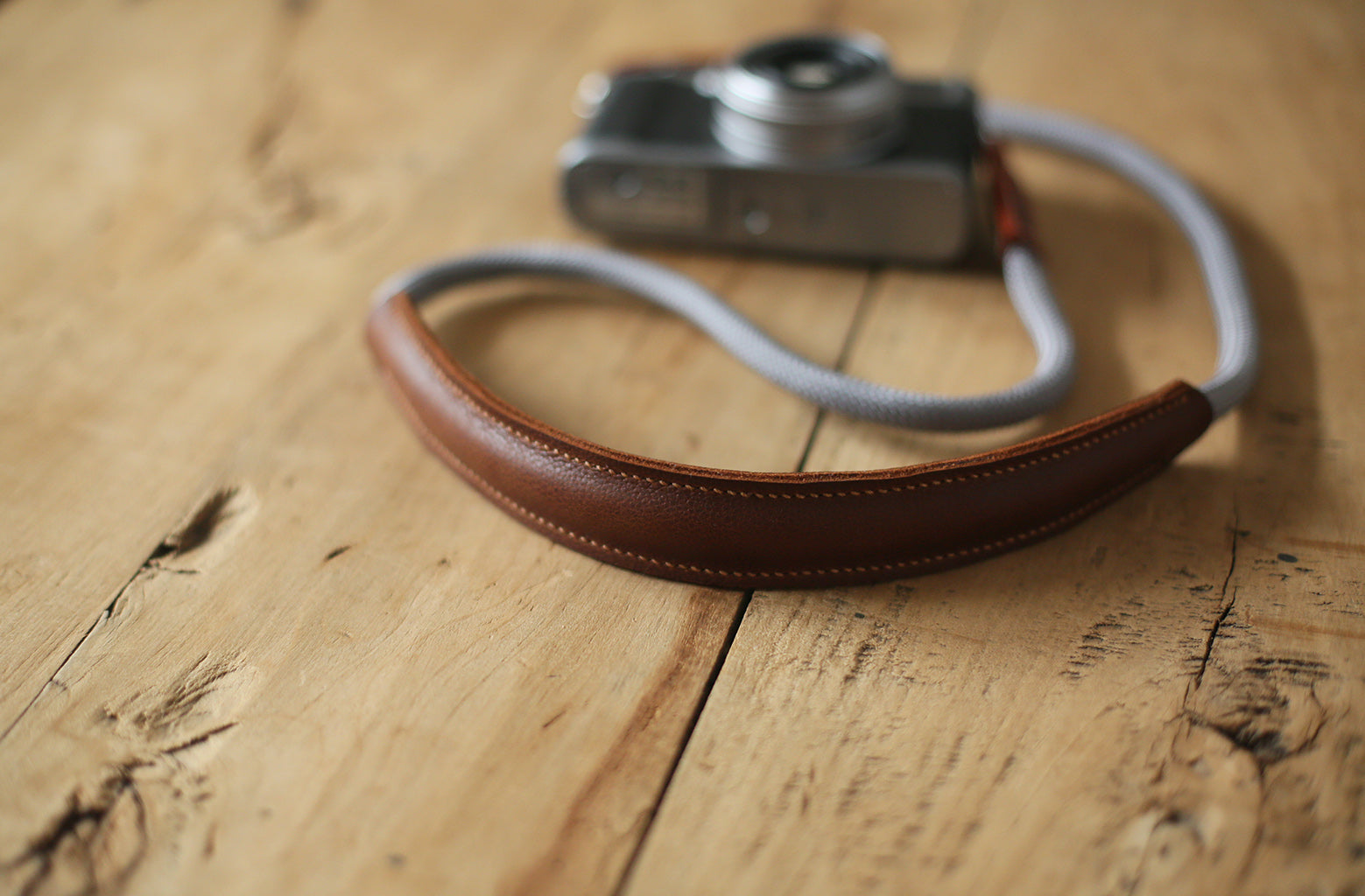 Lightweight travel camera strap on wooden tabletop