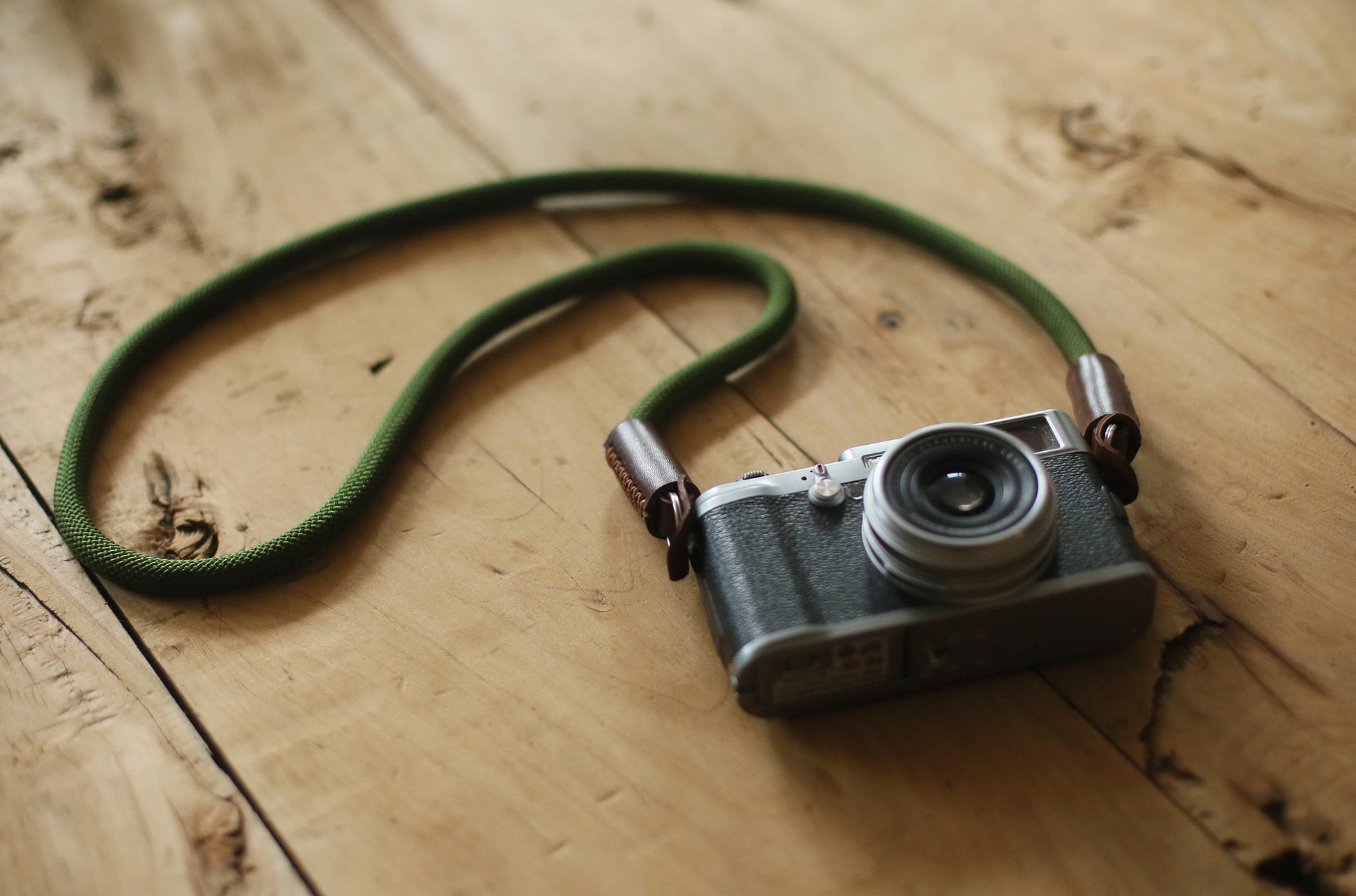 Handmade Windmup camera strap on wooden table