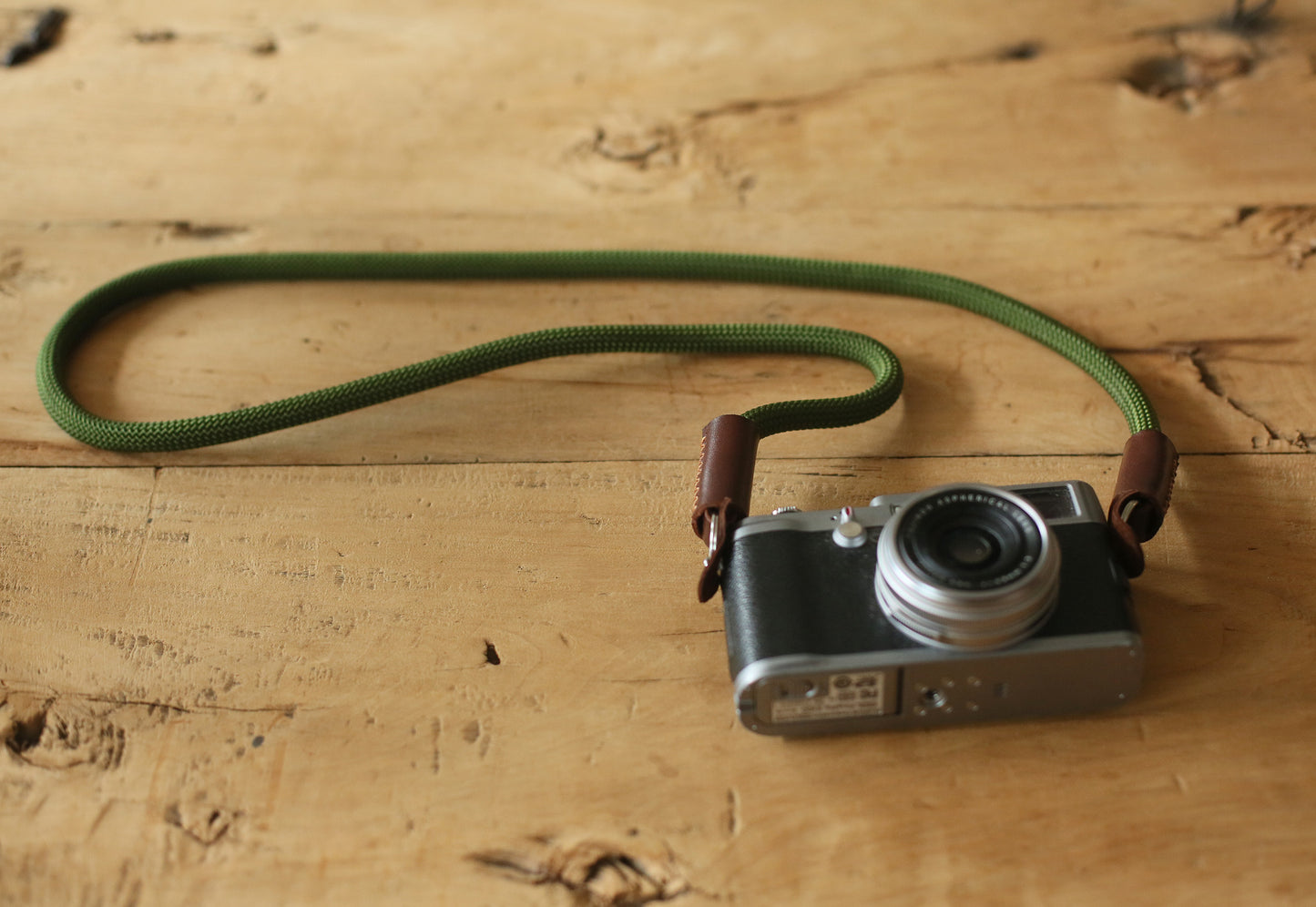Minimalist outdoor camera strap with hand-dyed tan leather